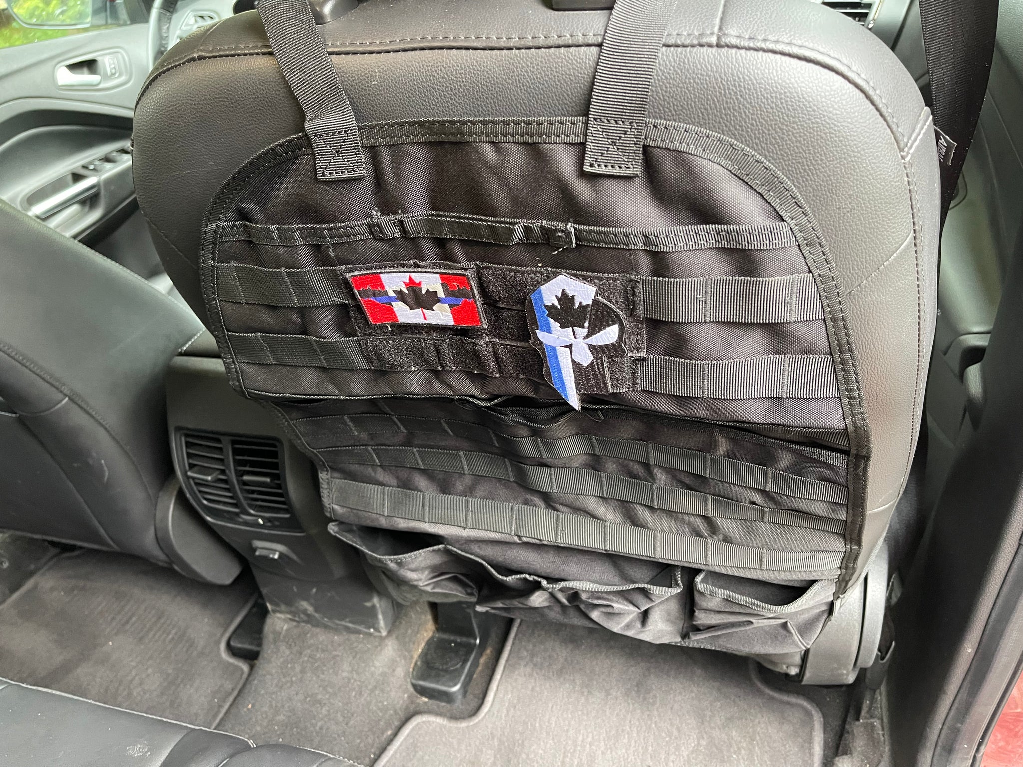 The Tactical MOLLE Car Seat Organizer is just a really cool